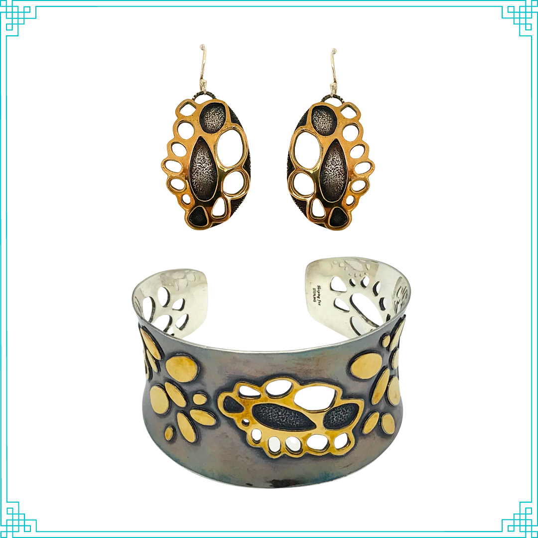 Sleeping Fox quality handmade silver jewelry presents Golden Doily Cuff Bracelet. This bracelet has a wonderful comfort fit due to it's anticlastic shape. Anticlastic means the material has a curve going in two different directions. The base material is silver and the top elements are brass. The outer face of the piece has been given a patina of black and the patina has been polished off the brass. Matching earrings, Golden Doily, are pictured with the bracelet. Sold seperately.