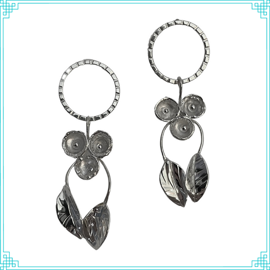 Sleeping Fox handmade sterling silver earrings with three grouped flowers and two leaves on stems hanging from the posted top circle.
