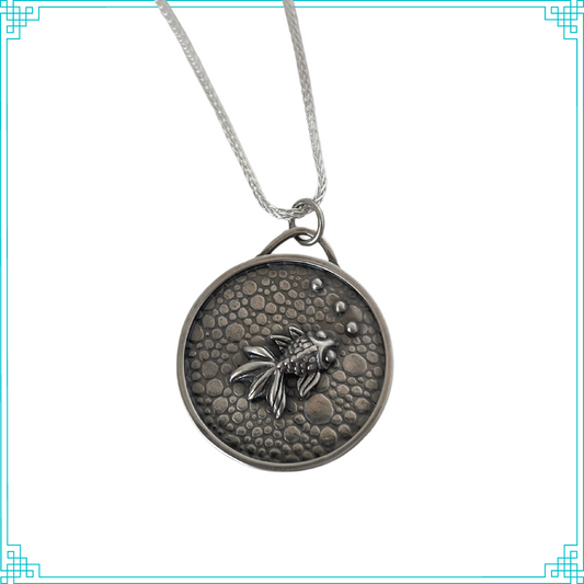 Sleeping Fox handmade silver jewelry pendant features a fish with bubbles swimming in a pebbled cement pond.