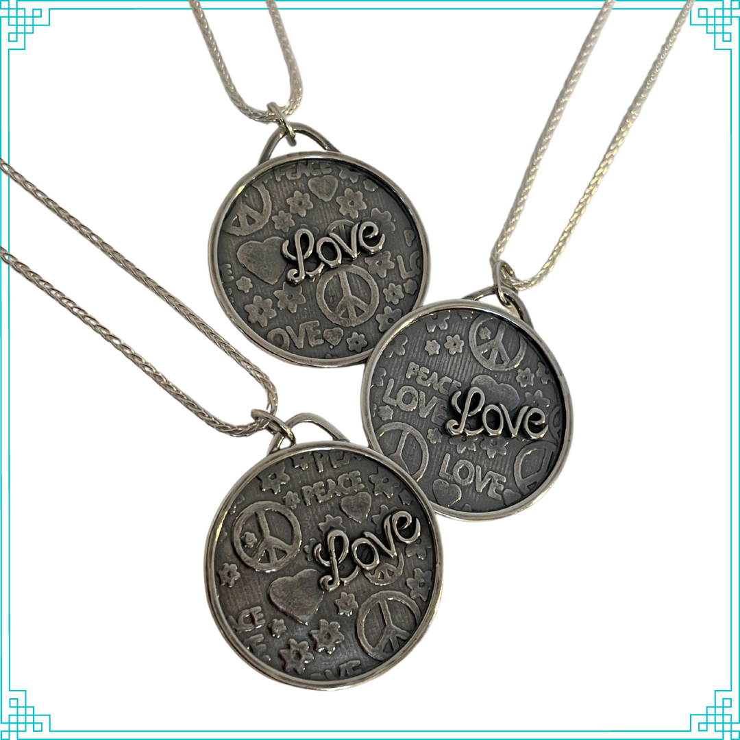 Sleeping Fox silver jewelry pendant with Peace and Love background and raised Love script lettering, hanging from 18' wheat chain.