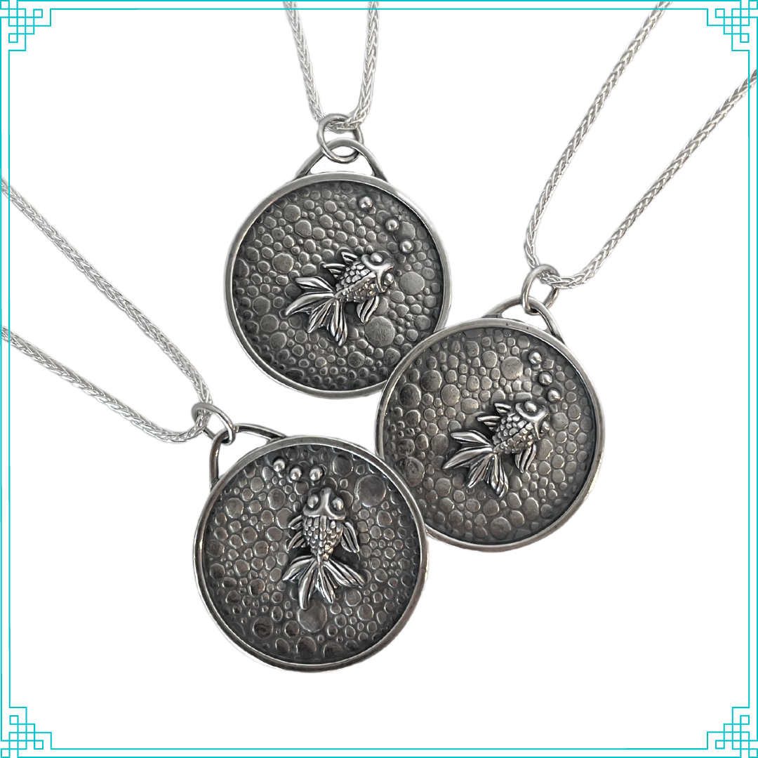 Sleeping Fox handmade silver jewelry pendant features a fish with bubbles swimming in a pebbled cement pond.