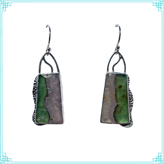 Sleeping Fox quality handmade sterling silver jewelry presents Divided. Nature created these stones of amethyst and florite which are divided down the middle, giving this piece its name. The silver design around the stones compliments and adds to the division line.