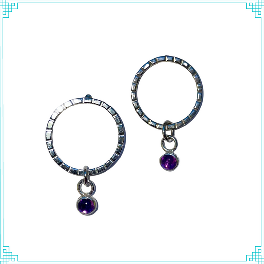 Sleeping Fox handmade sterling silver earrings feature a quality 4mm amethyst stone set in a bezel hangs from line textured circle with post.