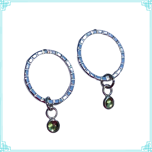 Sleeping Fox handmade sterling silver earrings feature a quality 4mm peridot stone set in a bezel hangs from line textured circle with post.