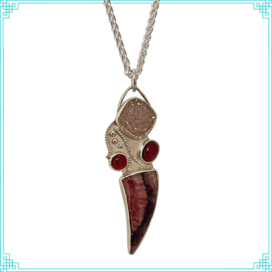 Sleeping Fox quality handmade sterling silver jewelry presents Ms Mermaid Pendant flowing with the current. The top stone is Brazilian Agate drusy, bottom stone is Rhodochrosite and the two red stones are semi-precious rubellite.
