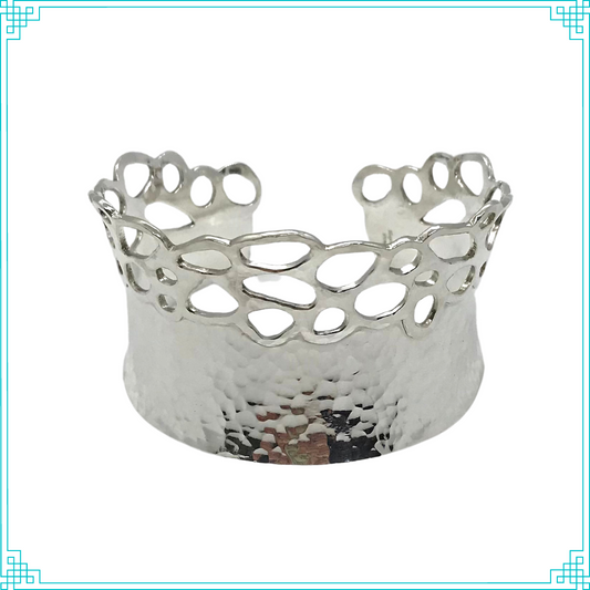 Sleeping Fox quality handmade silver jewelry presents Planished Beauty Cuff Bracelet. This crown of silver adorns your wrist with comfort due to its anticlastic shape. Anticlastic means the material has a curve going in two different directions. This is a special piece you may wear on your next date night. This design features hammer texture and double layers of silver where the cut outs occur.