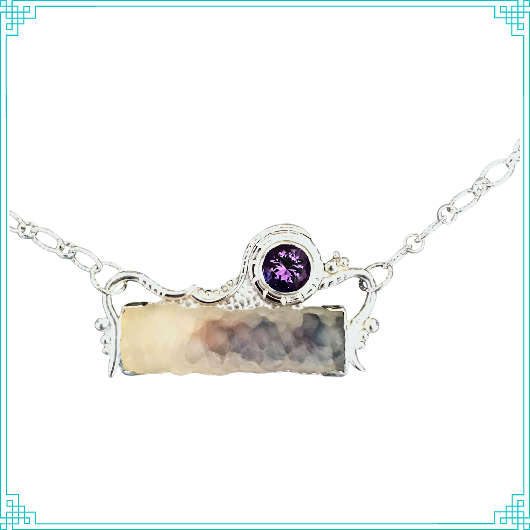 The main body of petrified bamboo (technically agate) is special because during its growth and petrification process minerals flowed through the center of the open cavity to create the purple color within, as seen from the outside. The 9mm amethyst is hand faceted locally with an opening in the back to better allow light to shine through and give it brilliance. Both stones are showcased with embellishments. The sterling silver setting is integrated with the chain.