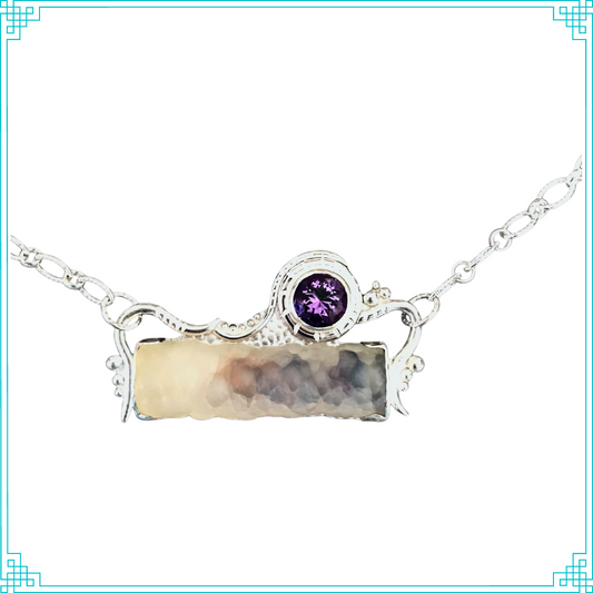 The main body of petrified bamboo (technically agate) is special because during its growth and petrification process minerals flowed through the center of the open cavity to create the purple color within, as seen from the outside. The 9mm amethyst is hand faceted locally with an opening in the back to better allow light to shine through and give it brilliance. Both stones are showcased with embellishments. The sterling silver setting is integrated with the chain.