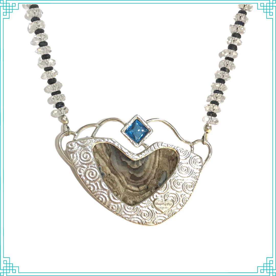 Sleeping Fox quality handmade sterling silver jewelry presents unique stones in Running Waters Pendant. The backside has a heart-shaped cut out to reveal the interesting growth patterns of the stone.