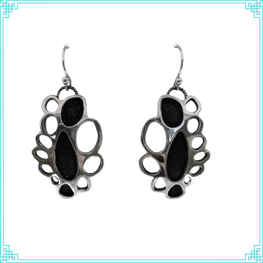 Sleeping Fox handmade silver jewelry presents Silver Doily Earrings. This two layer design gives a unique doily look because of the oval cut-outs around the filled in chambers in the center. Earrings hang from a handmade sterling silver earwire.