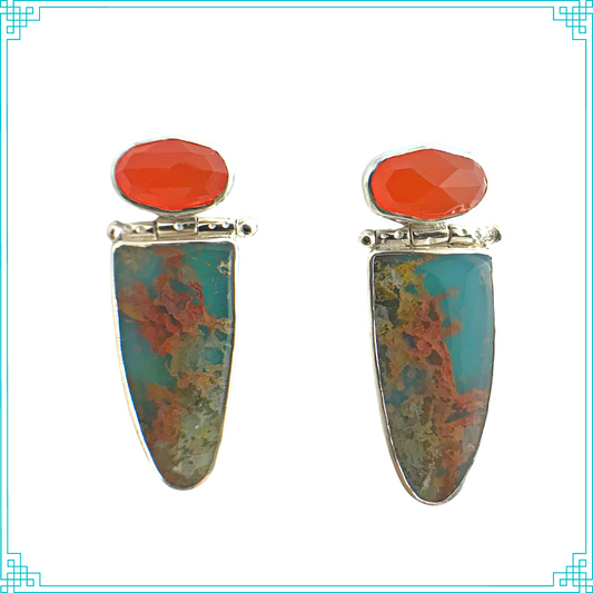 Sleeping Fox quality handmade sterling silver jewelry presents Surfside Earrings. The eye is immediately drawn to the bright and bold orange faceted carnelian. Under the swinging hinge, the bottom stones are graveyard plume agates, which are clear with orange inclusions, and bonded to turquoise stones on the back. The backsides have a random pattern and the earrings hang from a sterling post. Large sterling silver Ear Nuts are standard with all post earrings.