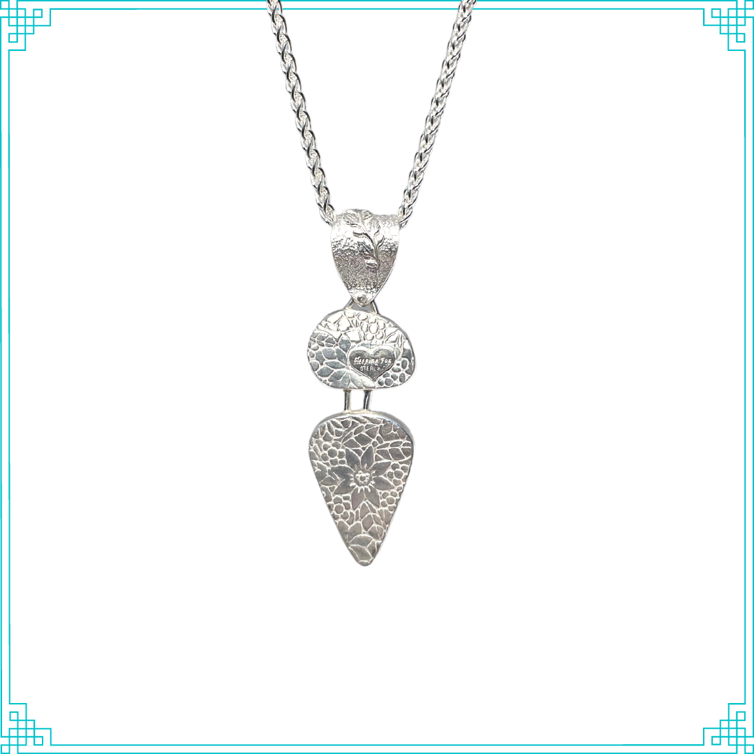 Sleeping Fox quality handmade sterling silver jewelry presents Three Turquoise Pendant. This pendent hangs from a 2.5mm sterling wheat chain. If you follow the vine behind the pendent you will find the pieces below are textured with flowers.