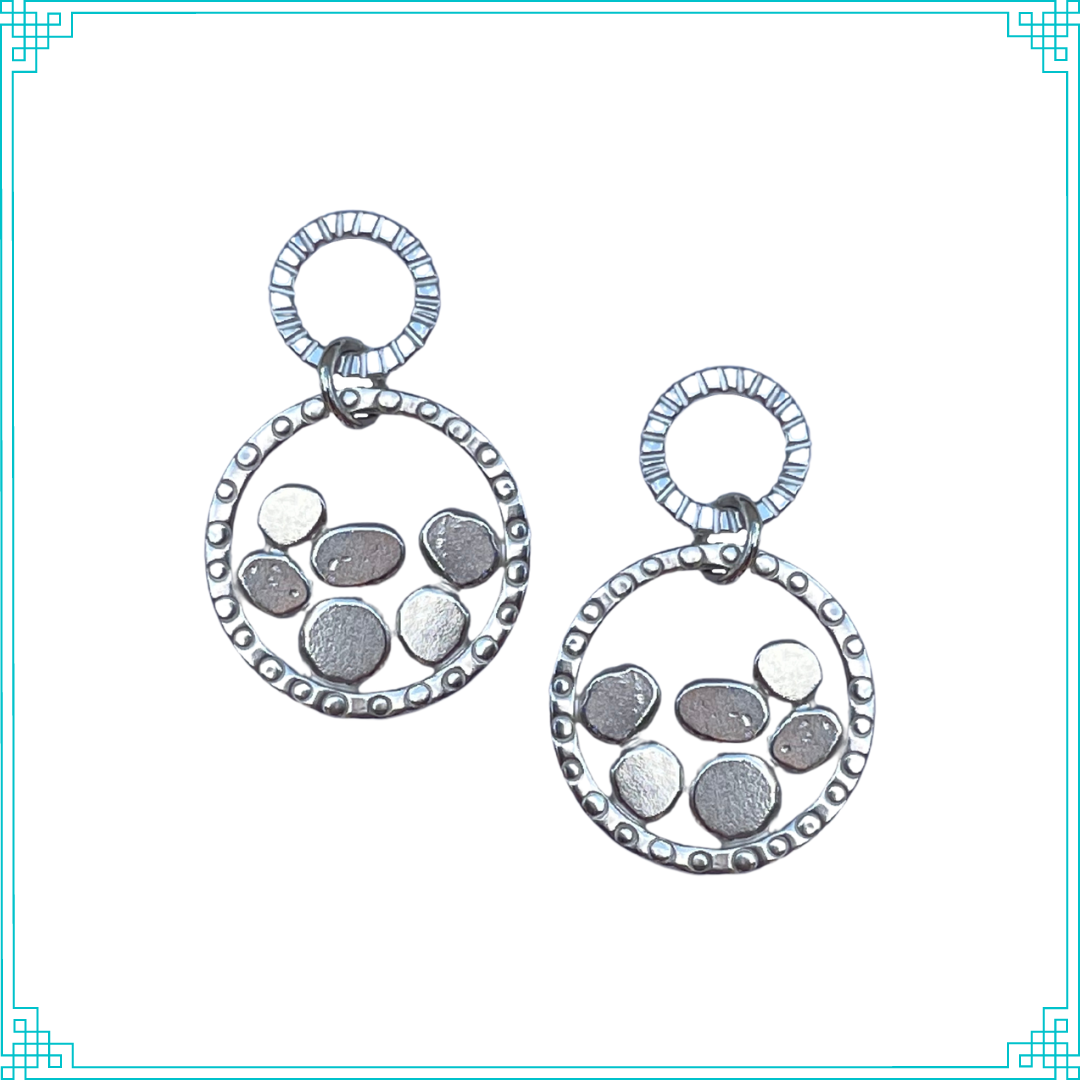 Sleeping Fox handmade sterling silver circular post earrings have a larger circle hanging with pebble like details inside.