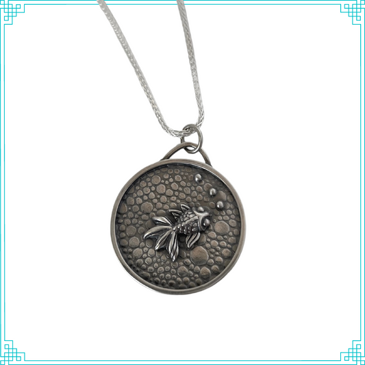 Sleeping Fox handmade silver jewelry pendant features a fish with bubbles swimming in a pebbled cement pond. 
