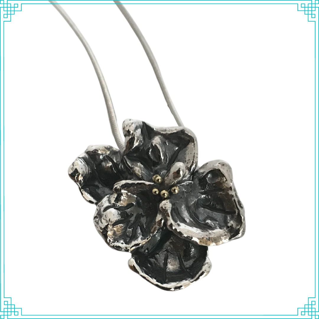 Five water cast organic petals soldered together with 18k gold anthers create the flower illusion. This pansy is blackened with patina to add to the dimension and contrast. This hangs from a sterling silver 1.5mm wheat chain at 18" in length.