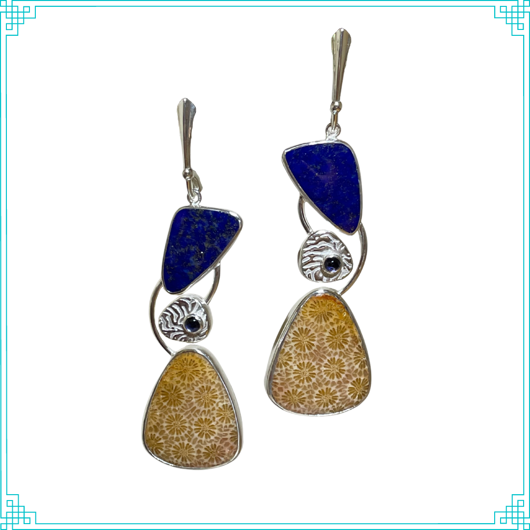 Sleeping Fox handmade silver jewelry presents these lever back earrings. Within three sections, the stones used are lapis, iolite, and petrified coral.