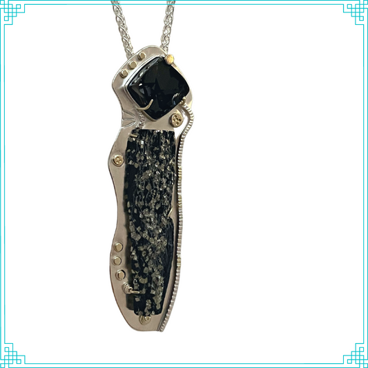 Sleeping Fox handmade sterling silver jewelry presents Golden Textures Pendant. This dynamic piece of German pyrite in slate is married with a black natural surface garnet layed onto a bed of fine silver. The 18k gold embellishments on the front and back truly make these rare stones pop. This hangs from a 18in silver wheat chain.