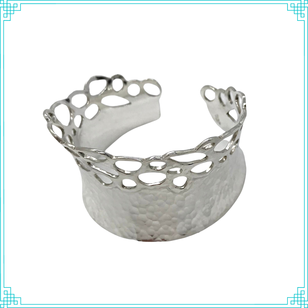 Sleeping Fox quality handmade silver jewelry presents Planished Beauty Cuff Bracelet. This crown of silver adorns your wrist with comfort due to its anticlastic shape. Anticlastic means the material has a curve going in two different directions. This is a special piece you may wear on your next date night. This design features hammer texture and double layers of silver where the cut outs occur.